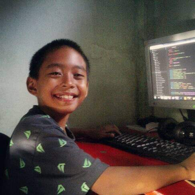 Sirilius Kevin, 10 years old is
      learning to code using a computer with Windows 7 OS.